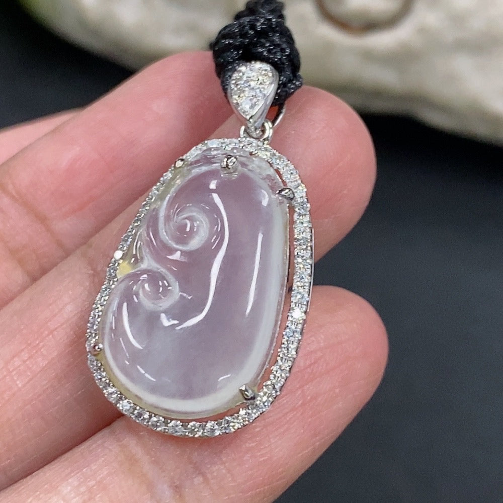 Jadeite Ruyi pendant with 18k gold and diamond accents, showcasing intricate inlay and a polished jade surface.