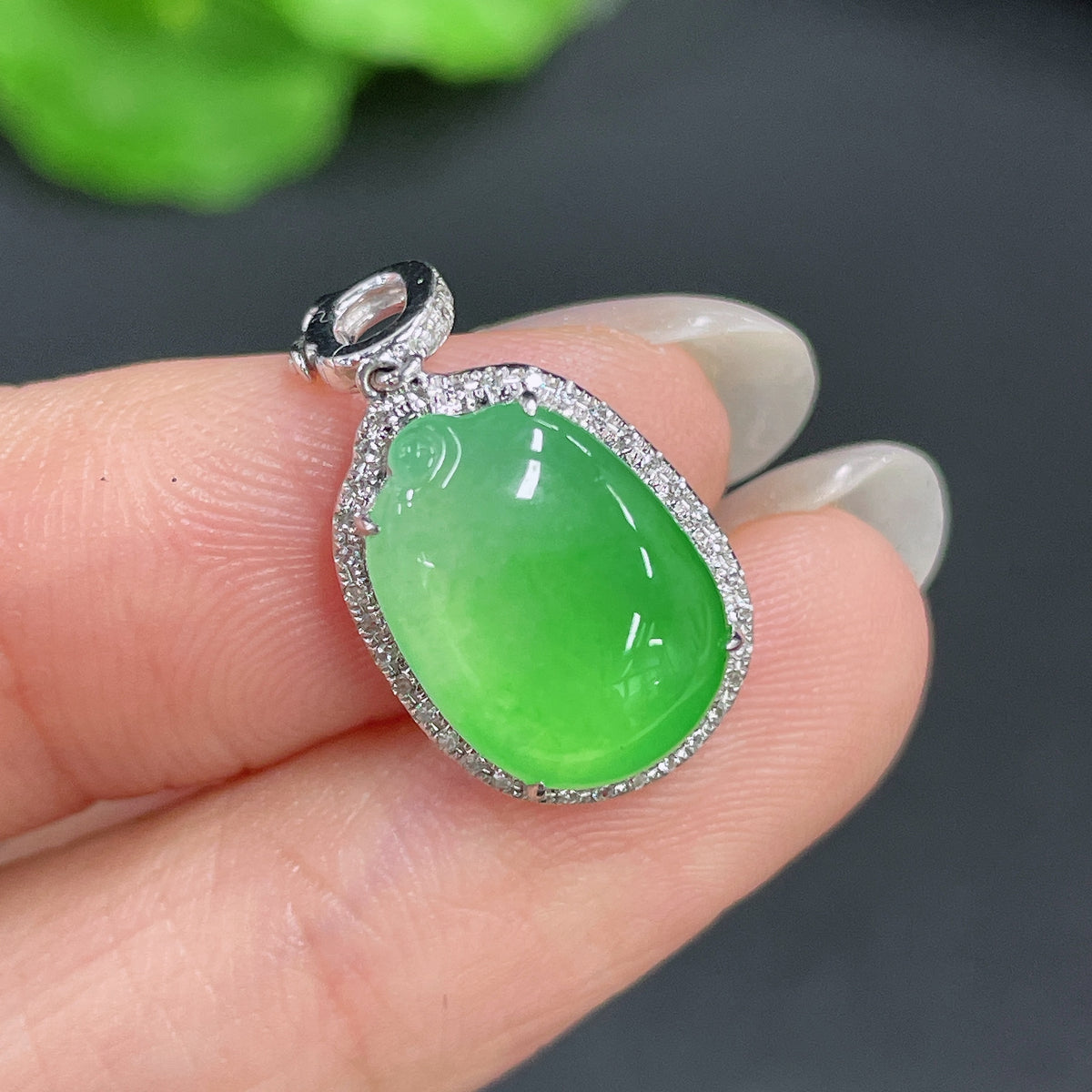 Jadeite pendant with 18k gold inlay and diamond accents, crafted by HKHQ, showcasing a polished jade gemstone.