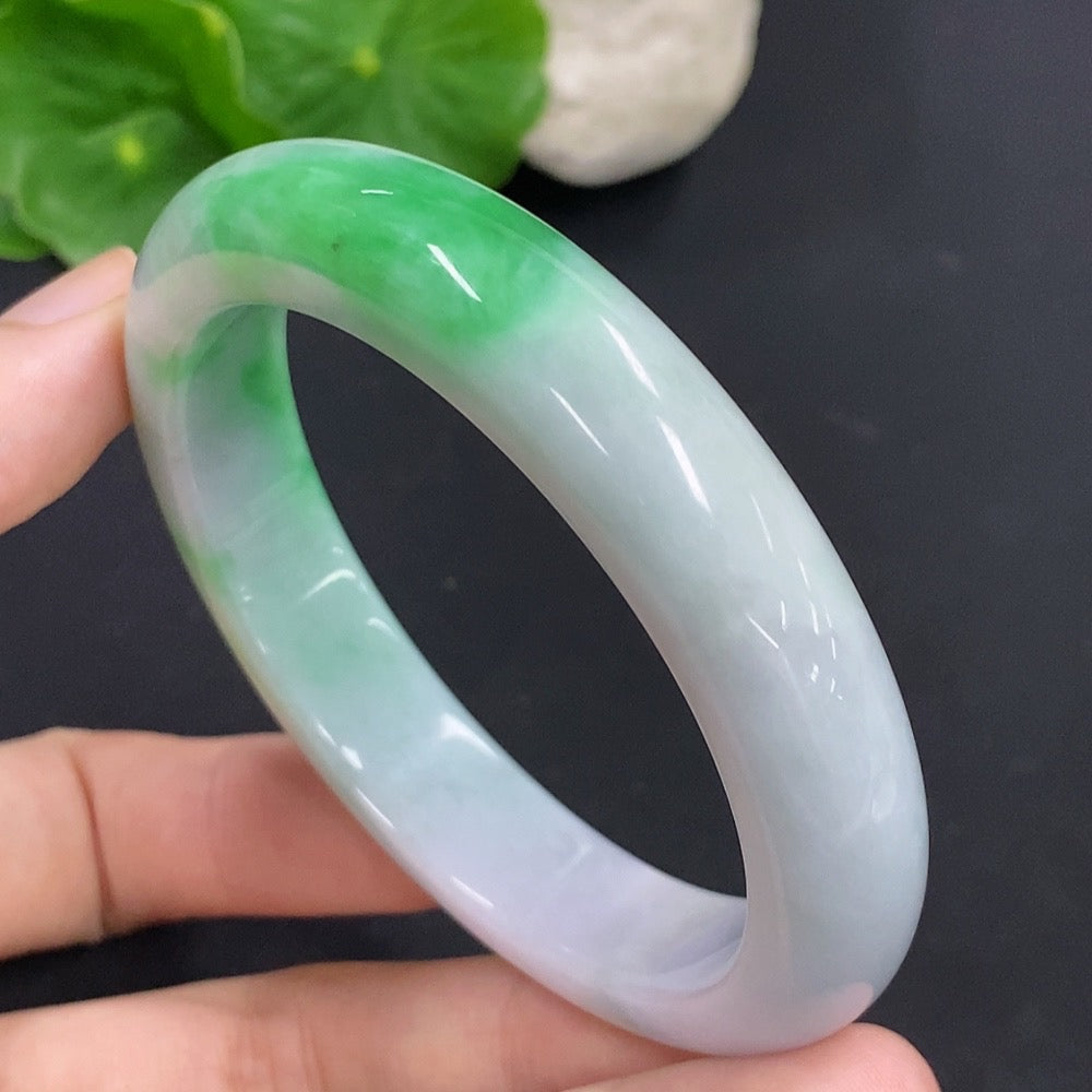 HKHQ jadeite round bangle with a 57.3mm size and 60.6g weight, showcasing smooth, polished green jadeite bracelet on a neutral background.