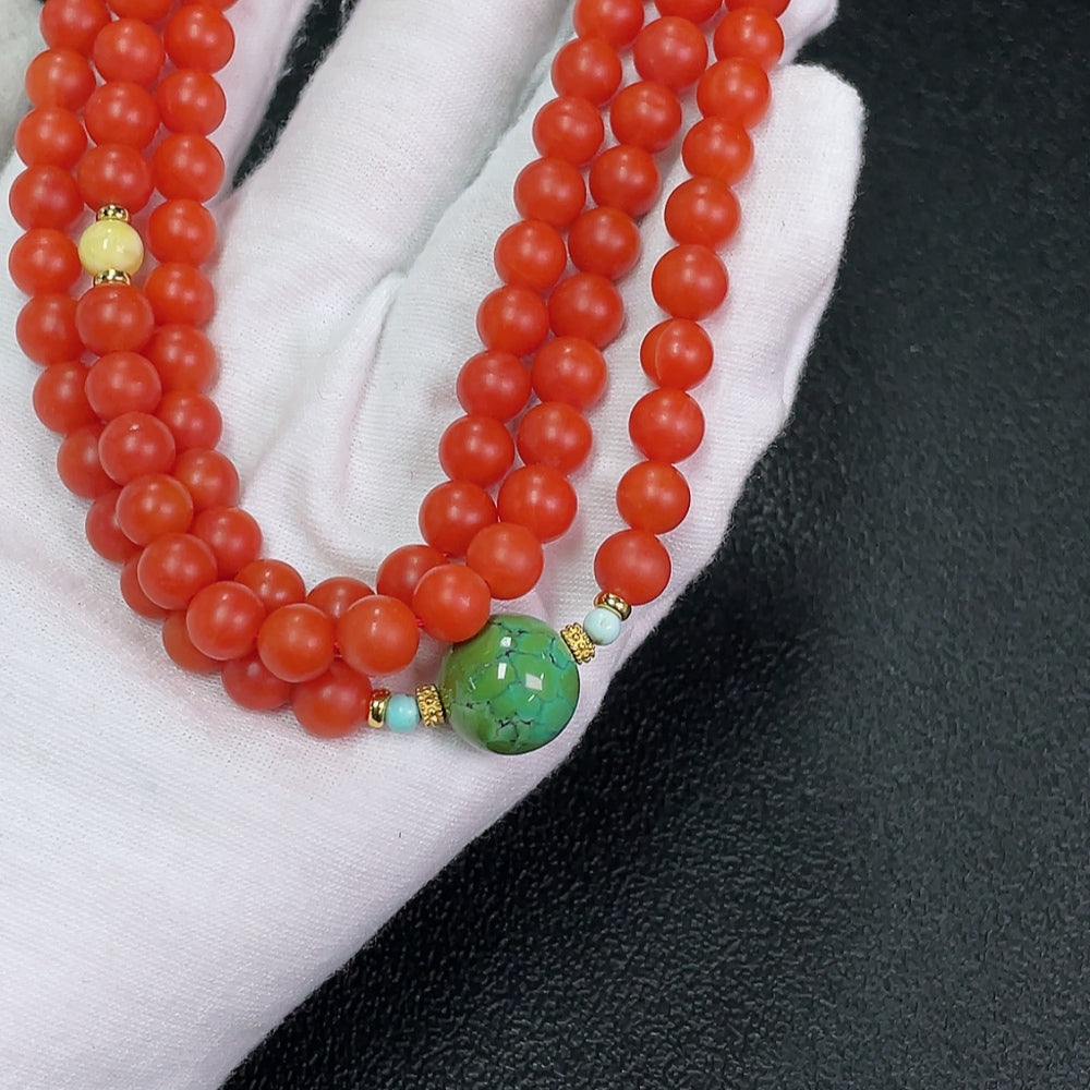 Amber bead strand featuring South Red Agate, turquoise, and non-metal accent stones with visible organic matter, 7mm beads.