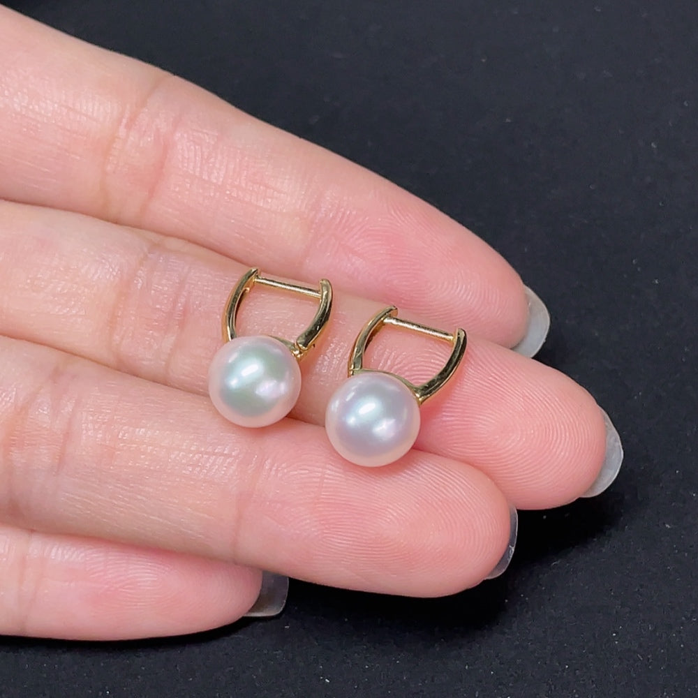 Elegant saltwater pearl earrings with 18K gold settings, featuring smooth pearls and delicate craftsmanship.