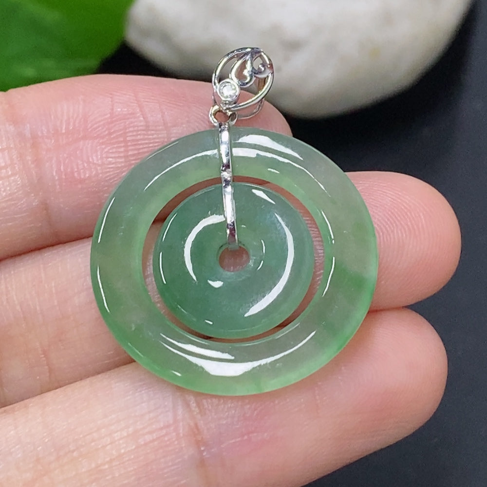Jadeite mother-and-child button pendant with 18K gold and diamond accents, featuring a detailed jade design and gold setting.