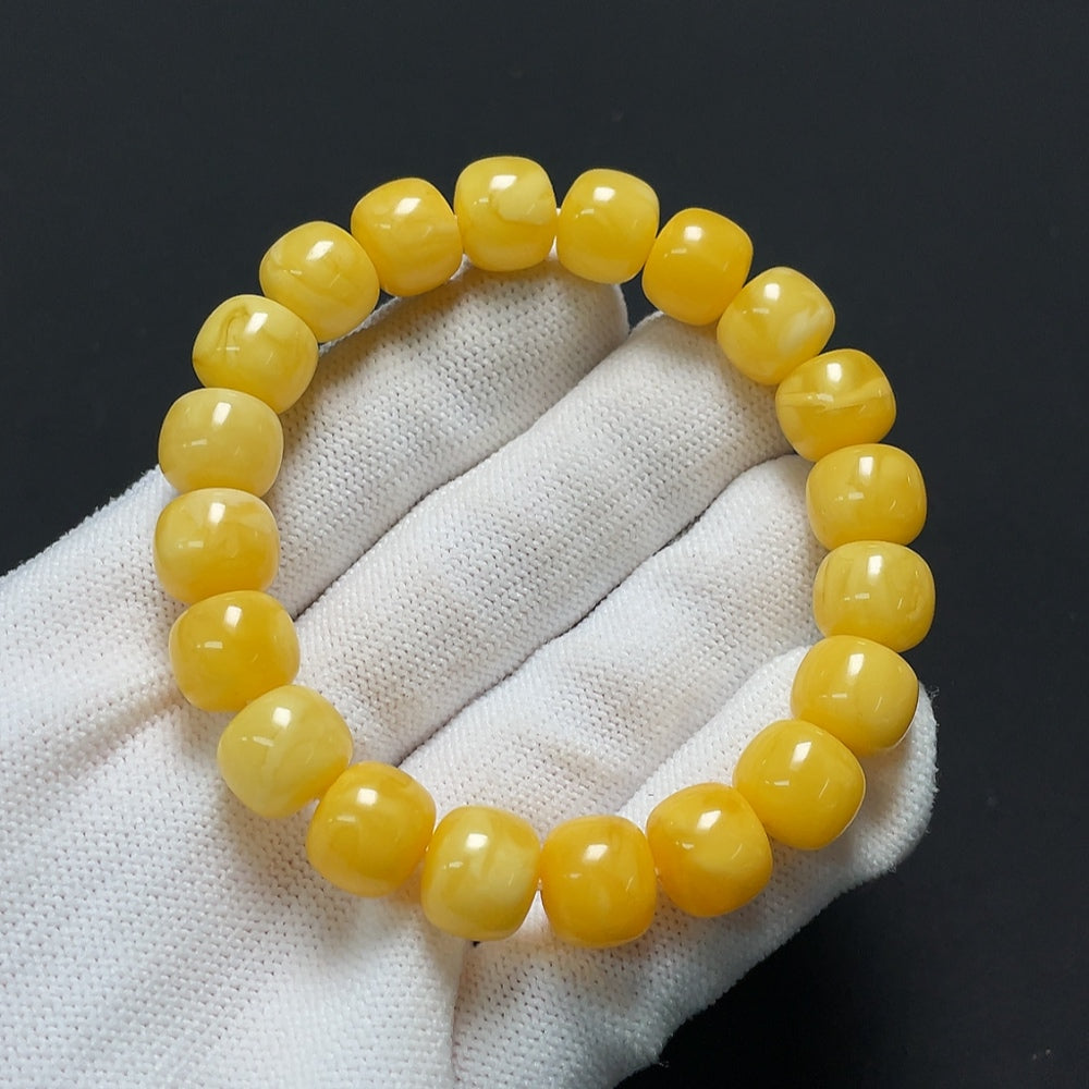 Amber beeswax bracelet with 10.6mm beads from HKHQ, weighing approximately 14.44g, featuring warm amber tones.