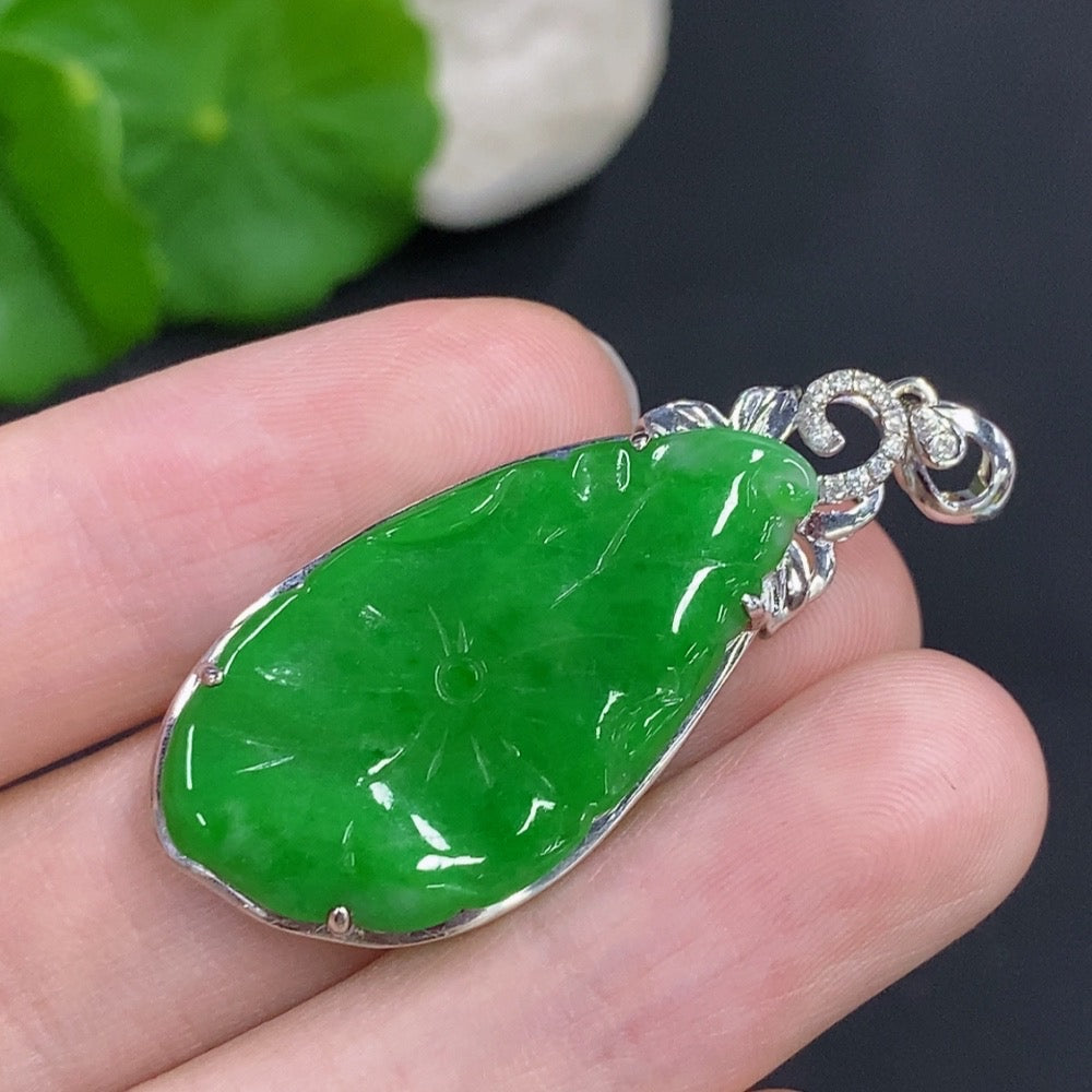 Jadeite lotus leaf pendant with 18K gold accents and diamond details, showcasing intricate craftsmanship and elegant design.