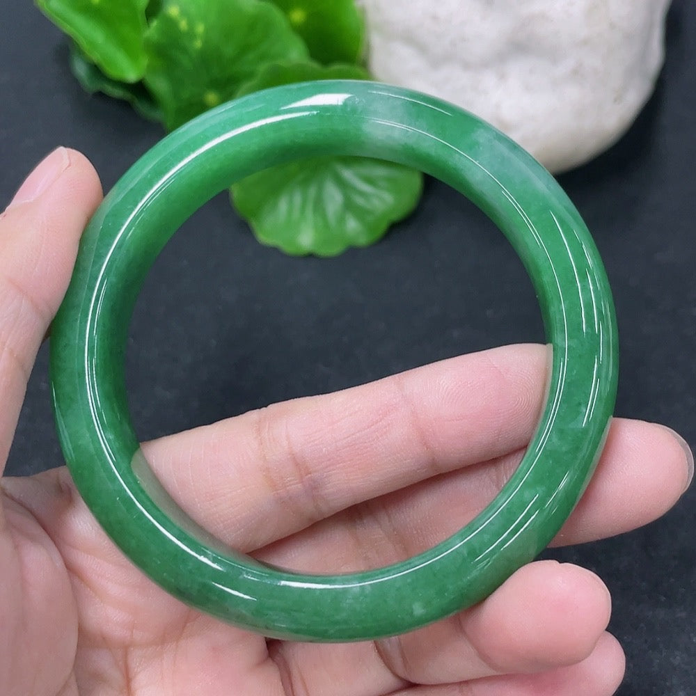 HKHQ jadeite round bangle with 53.8mm diameter and 49.13g weight, showcasing smooth, polished surface and vibrant green color.