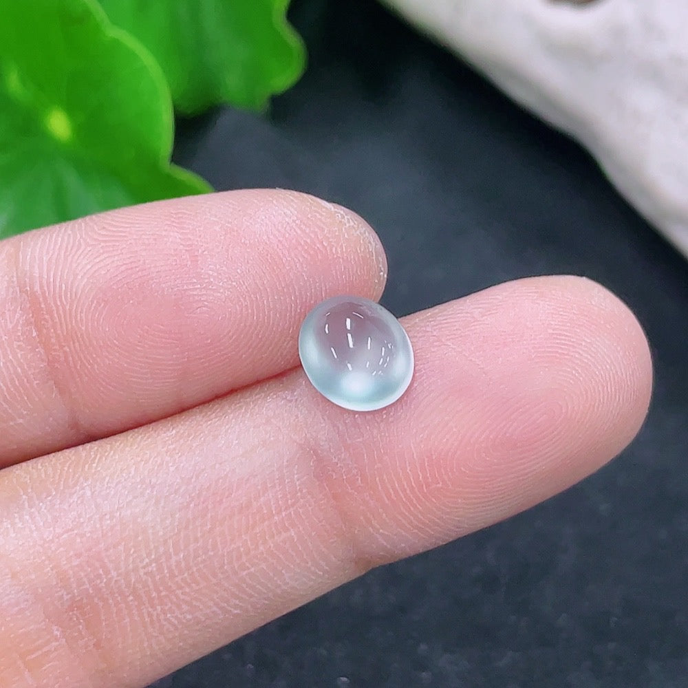 Jadeite cabochon jewelry piece from HKHQ, showcasing a smooth, polished green gemstone with a glossy surface.