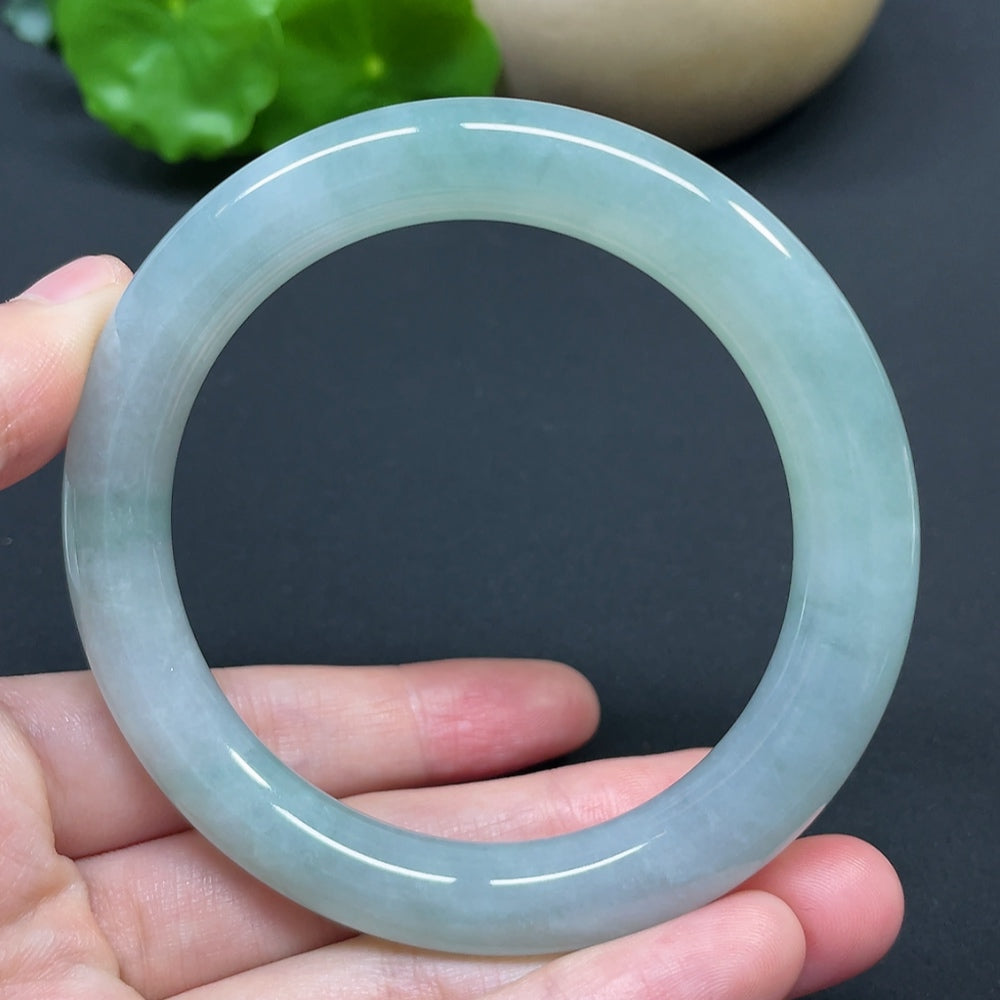 HKHQ jadeite round bangle size 56.8 with a smooth, polished surface and a weight of 53.94g, showcasing vibrant green color.