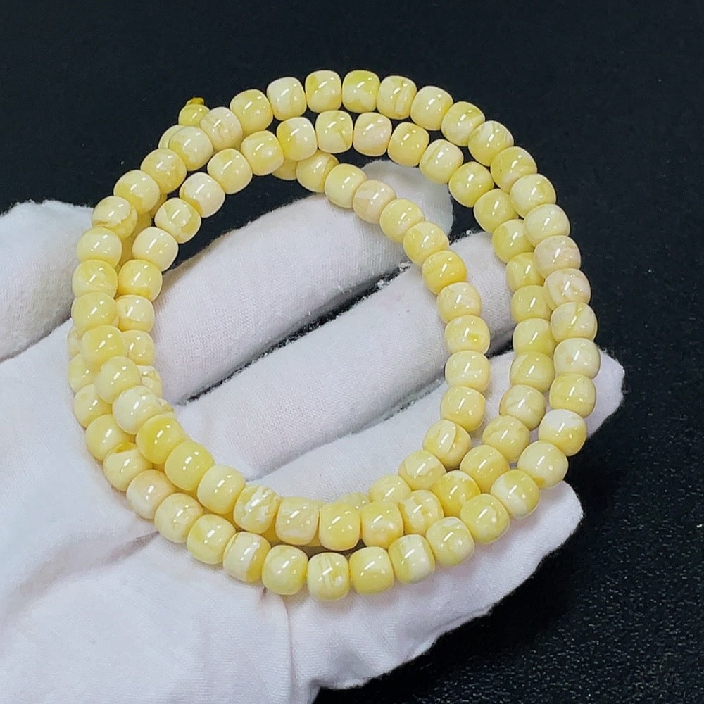 Amber beeswax gemstone bead strand, approx. 7.3mm, showcasing warm amber color and smooth beads, from HKHQ.
