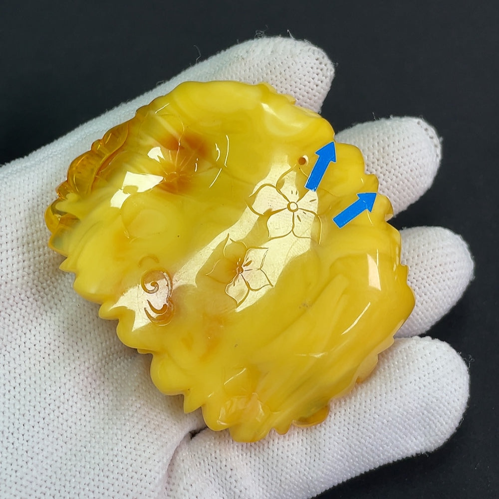 Amber beeswax pendant with partial visible repairs, weighing approximately 36.25g, from HKHQ, showcasing natural amber's warm tones.