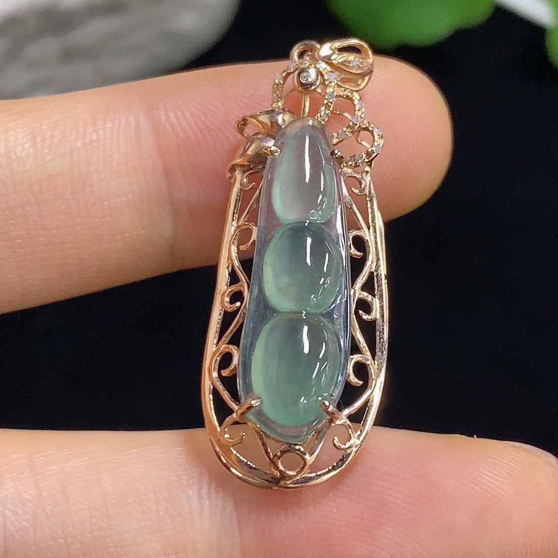Jadeite auspicious bean pendant with 18K gold and diamond accents, featuring a polished jade jadeite gemstone on a jewelry chain.