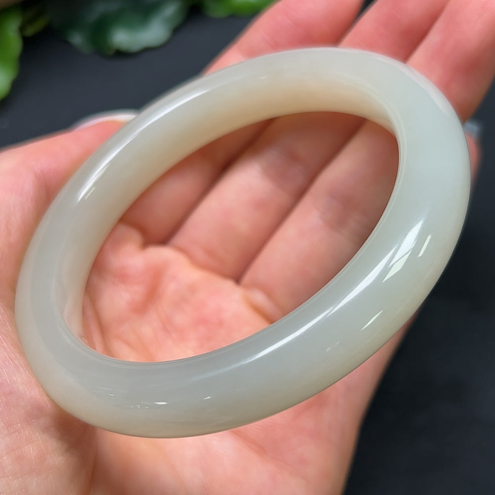 Hetian jade round bracelet by HKHQ, 58.9mm size, lightweight, smooth polished surface, showcasing natural jade texture and color.