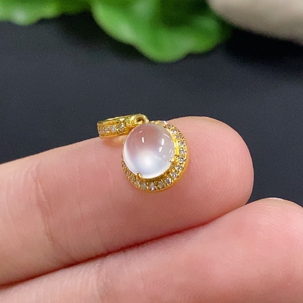 Jadeite cabochon pendant with 18K gold and diamond accents, featuring a delicate gold chain in a close-up view.