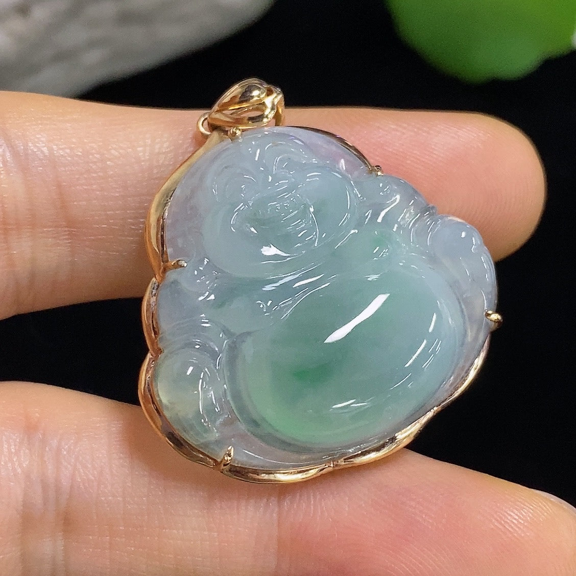 Jadeite Buddha pendant with 18k gold mounting, weighing approximately 6.31g, featuring a detailed Buddha figure on a smooth jade surface.