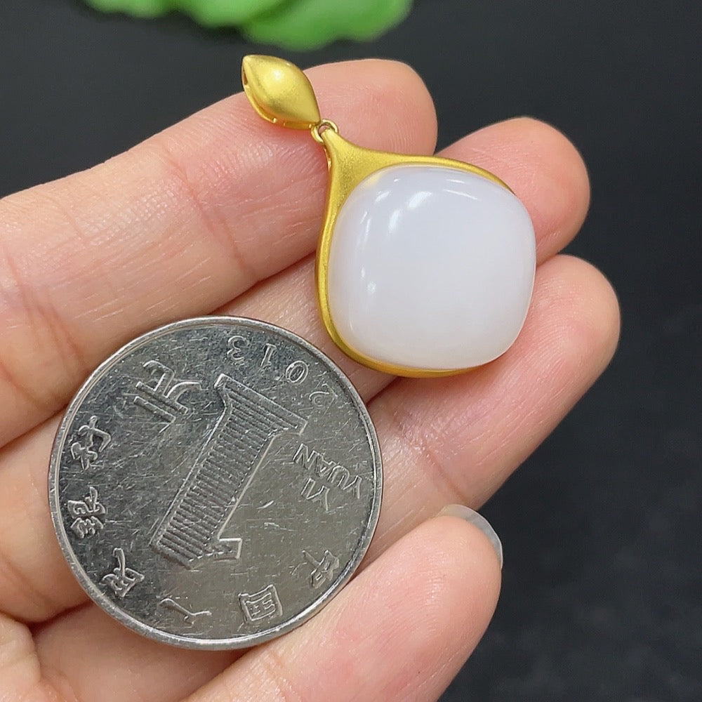 Hetian jade inlaid pendant necklace with 18K gold setting, featuring a smooth jade stone on a delicate chain.