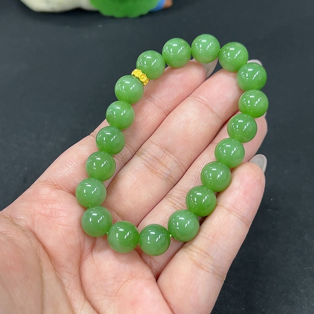 Hetian jade bracelet with 9.6mm beads, weighing approximately 30.1g, crafted by HKHQ, displayed in a close-up image.