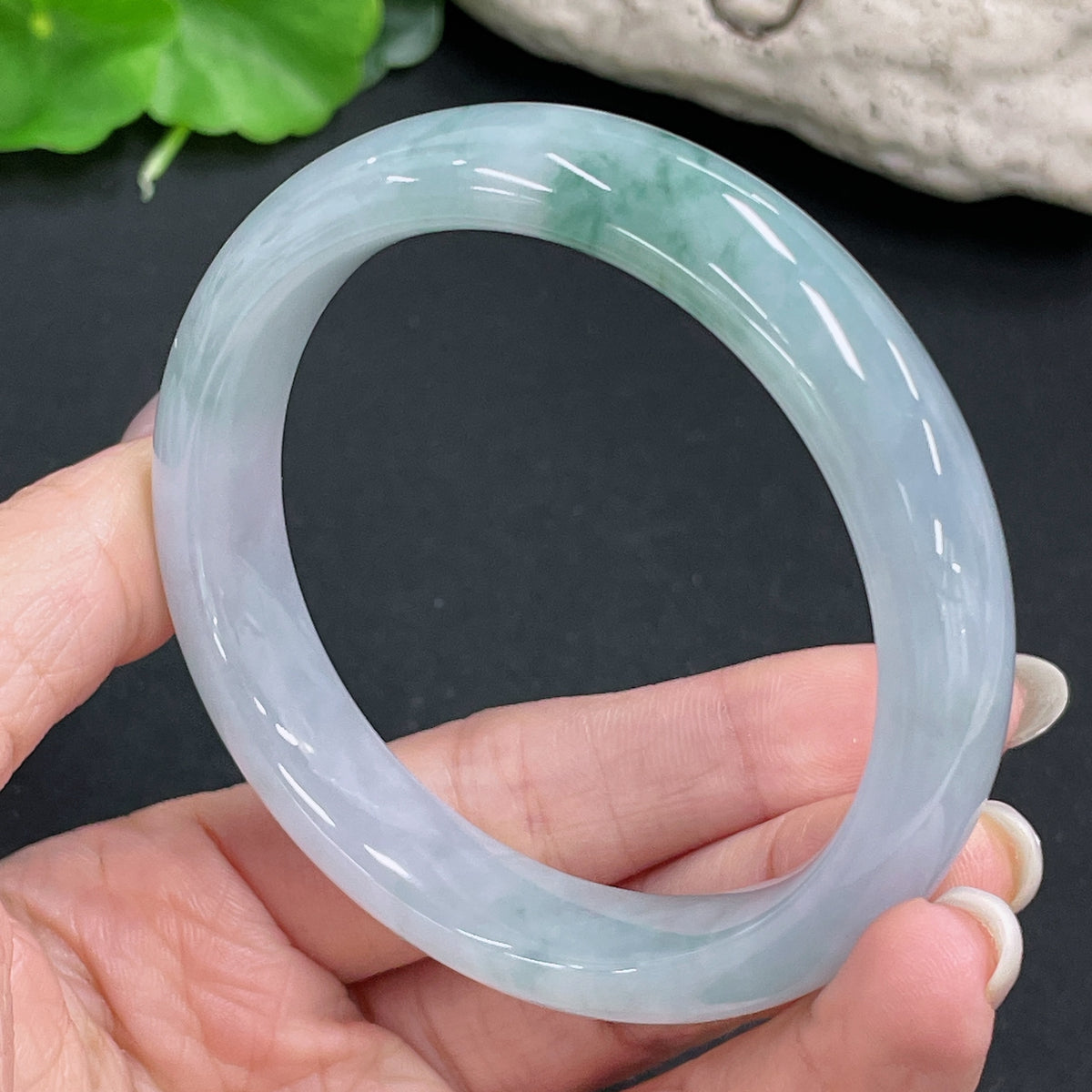 HKHQ jadeite round bangle weighing 54.6g with a size of 56.3, featuring smooth, polished jade surface in natural green color.
