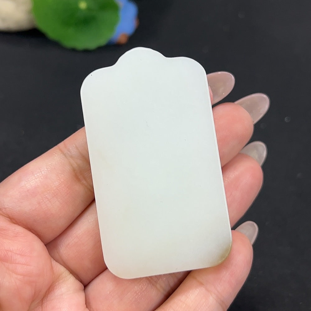 Hetian jade Guanyin pendant from HKHQ, weighing approx. 61.3g, featuring detailed carved design on smooth green jade surface.