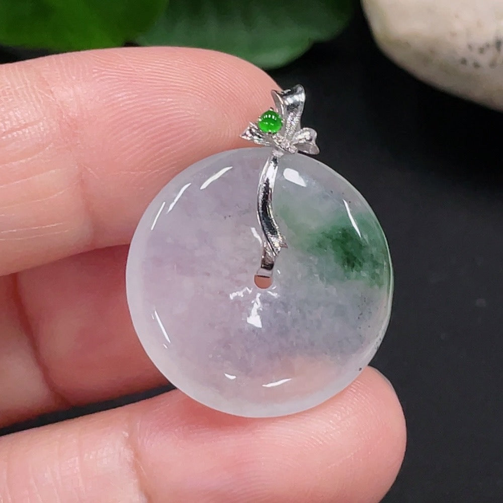 Jadeite Peace Knot pendant with 18K gold bail, crafted from smooth green jade, showcasing intricate knot design and polished finish.