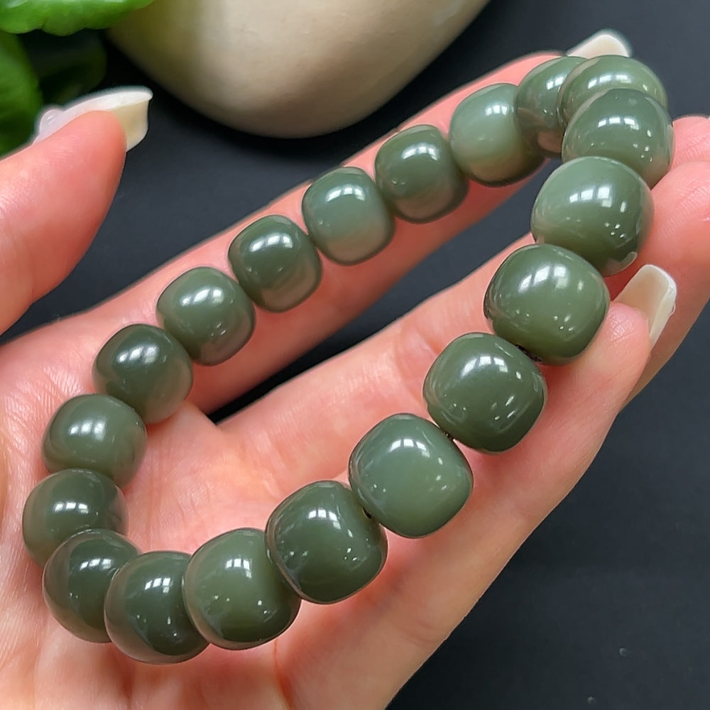 HKHQ Hetian Jade bracelet with 12mm round beads, showcasing smooth, polished green jade on a neutral background.