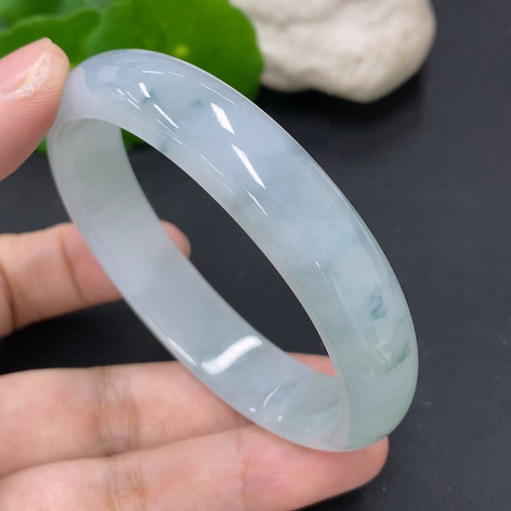 HKHQ jadeite oval bangle in size 56, weighing 43.7g, showcasing smooth, polished green jadeite with a subtle oval shape.