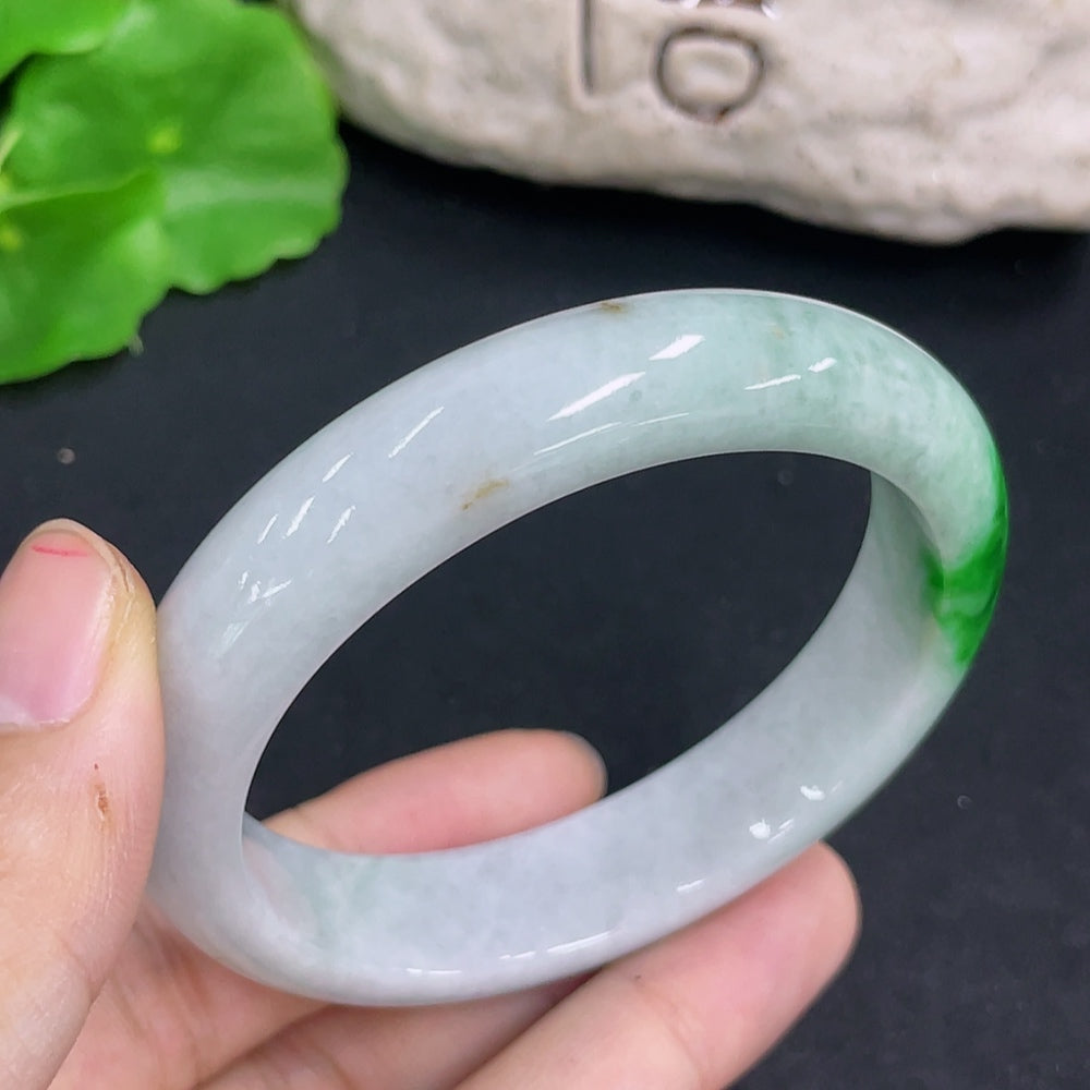 Jadeite oval bracelet featuring smooth green jade stones, crafted by HKHQ, displayed on a neutral background.