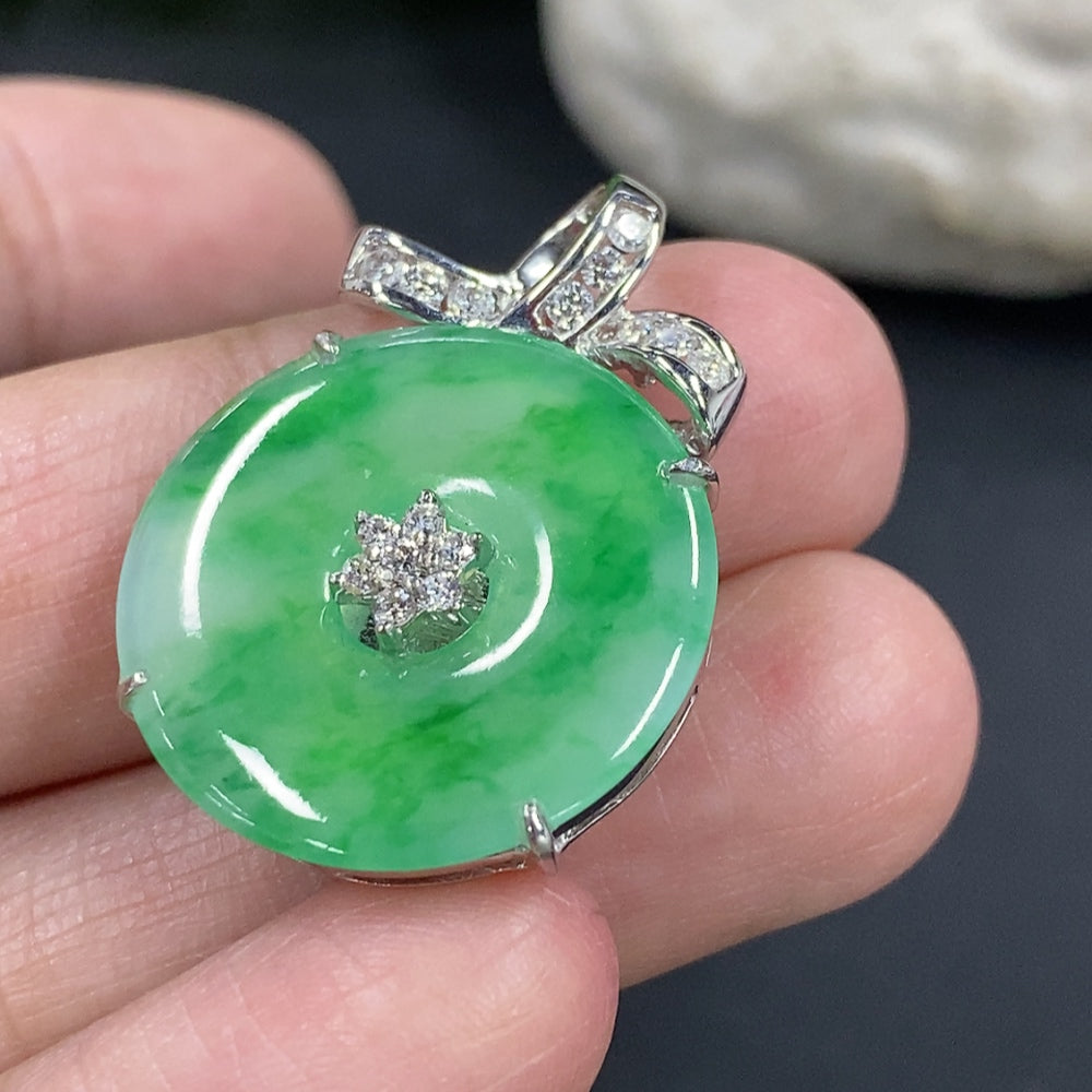 Jadeite Peace Knot pendant with 18k gold setting and diamond accents, shown on a necklace chain.