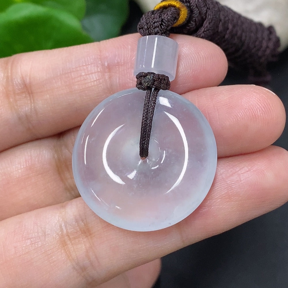 HKHQ jadeite pendant featuring a peace knot design, weighs approximately 14.58g including cord, showcasing smooth green jade craftsmanship.