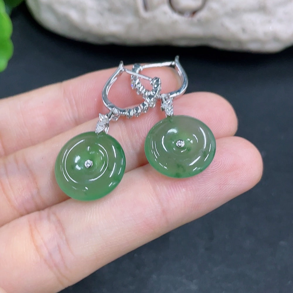 Jadeite Peace Knot earrings by HKHQ with inlaid designs, crafted in 18k gold, weighing approximately 5.14g.