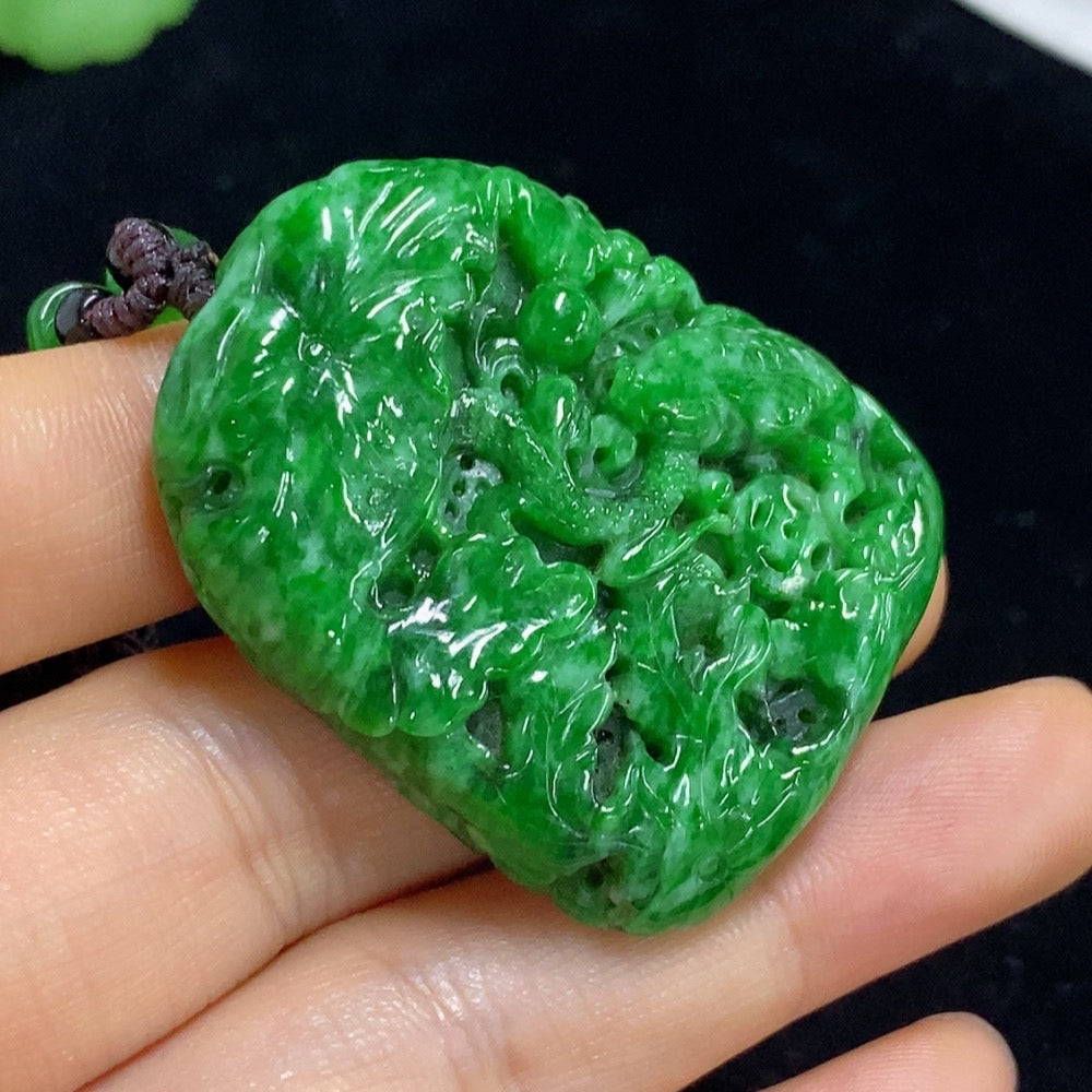 Jadeite landscape pendant with mineral inclusions, weighs approximately 30.56g, featuring a jade pendant on a rope chain.