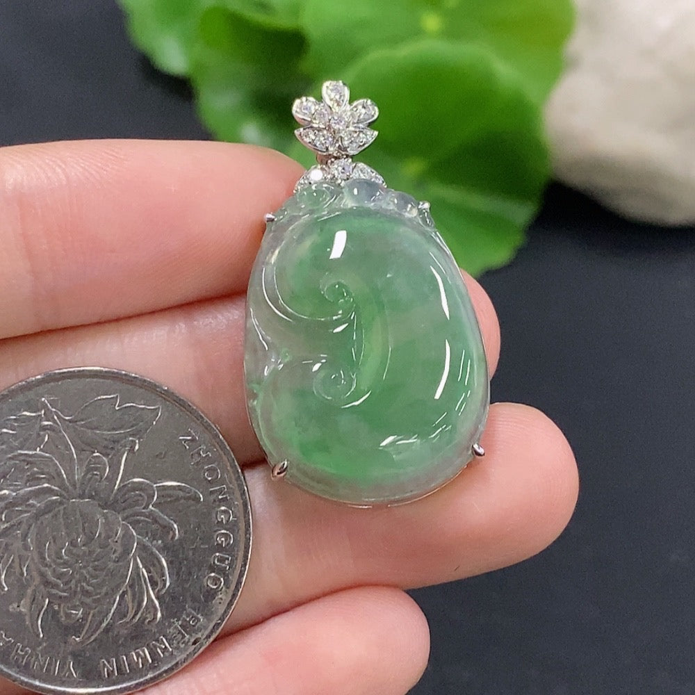 Jadeite Ruyi pendant with 18K gold and diamond accents, showcasing intricate inlay and polished jade surface.