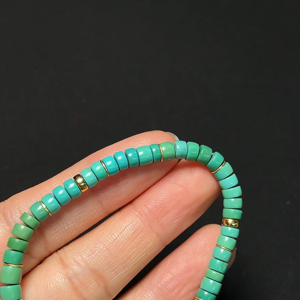 18K gold turquoise bracelet with 4.7mm beads, total weight 7.02g, featuring vibrant turquoise stones and gold clasp.