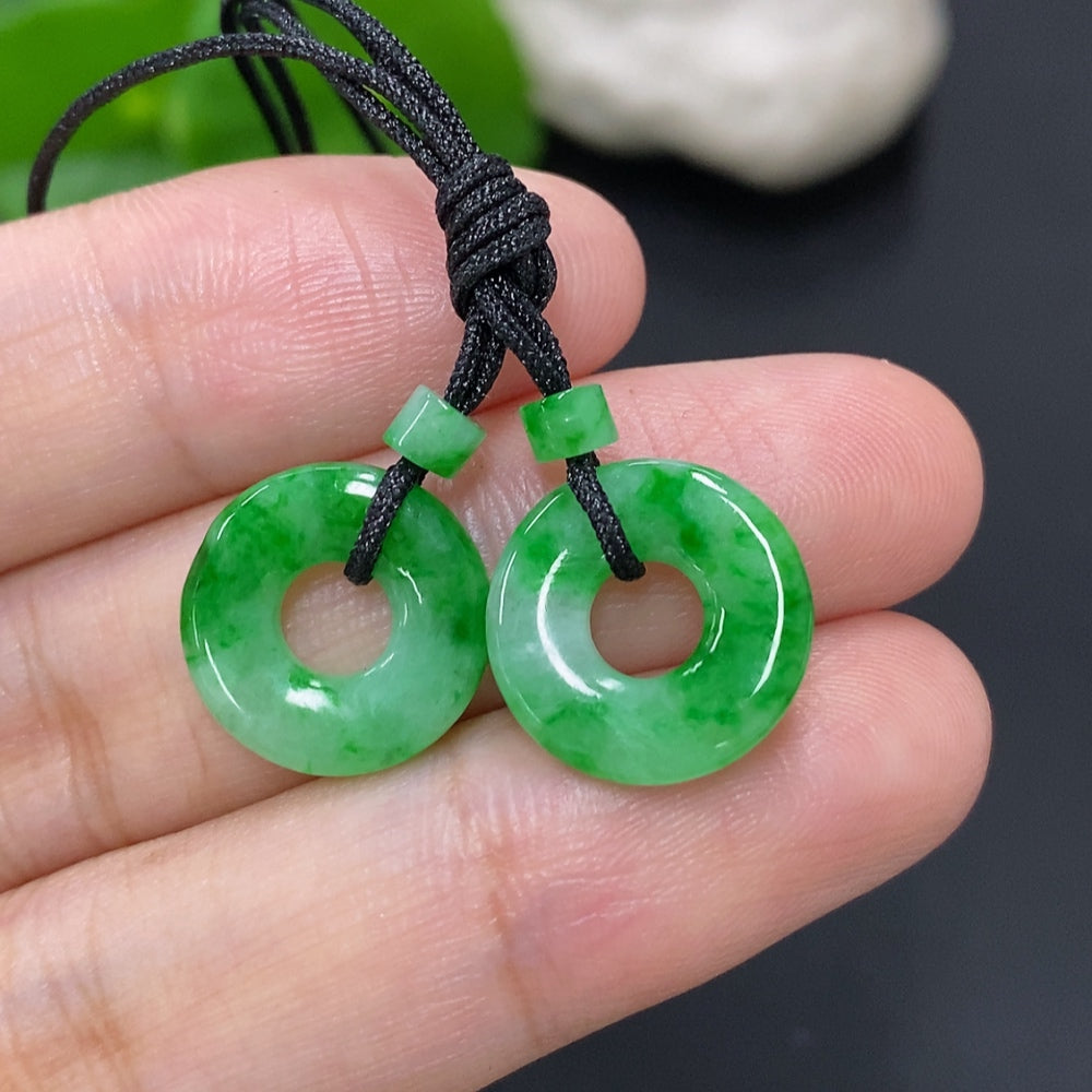 Set of jadeite donut pendants for necklaces, approximately 2.3g total weight, showcasing smooth green jadeite in natural light.