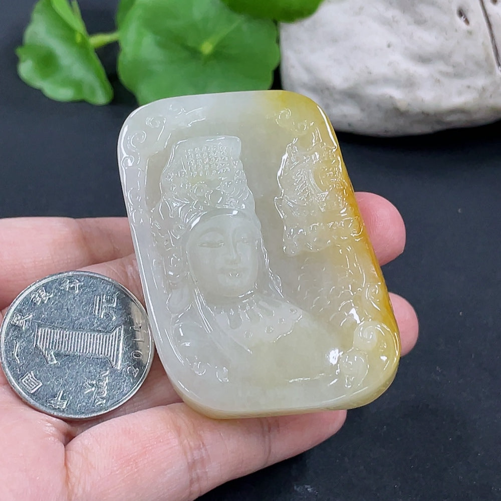Jadeite Guanyin pendant with intricate carved details, weighing approximately 64.7g, crafted by HKHQ, displayed against a neutral background.