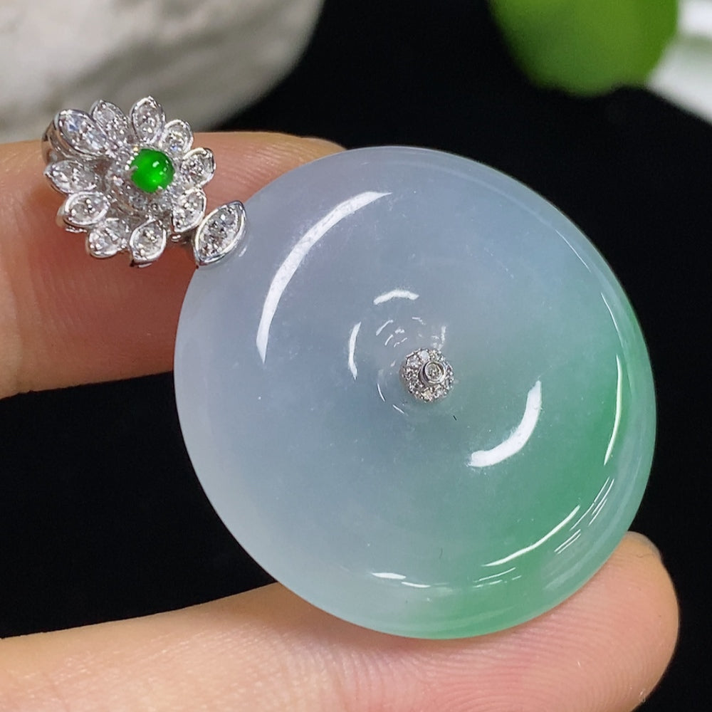 Jadeite pendant with peace buckle design by HKHQ, 18k gold with diamond accents, weighs approximately 11.6 grams.