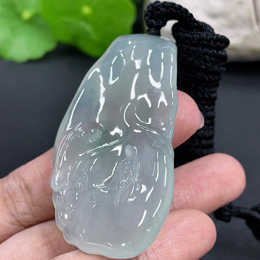 Jadeite Formless Guanyin pendant in green jade, showcasing smooth, polished surface and intricate carved details.