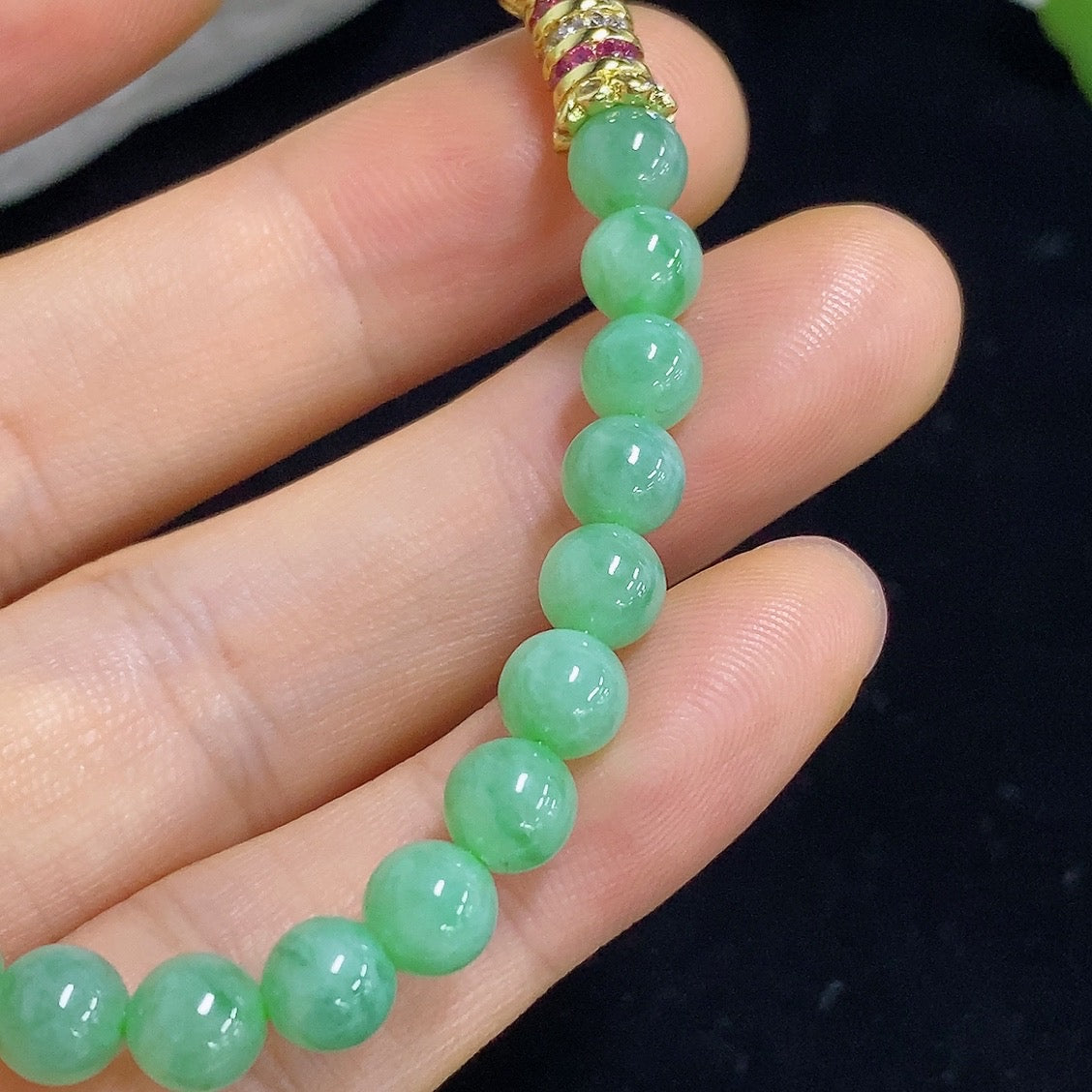 Jadeite bracelet with 5.6mm jade beads, non-gold, weighing approximately 11.96g, featuring smooth, polished jade stones.