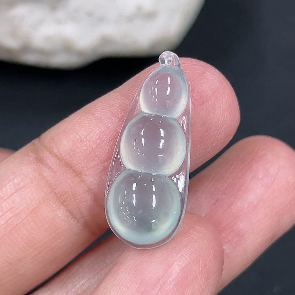 Jadeite auspicious bean inlay piece from HKHQ, weighing approximately 1.88g, featuring smooth green jade with intricate inlay details.
