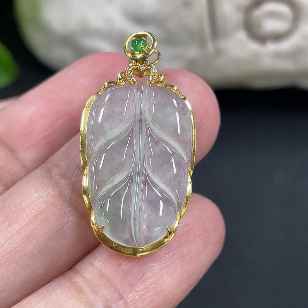 Jadeite leaf pendant with 18k gold inlay and diamond accents, elegant jewelry piece by HKHQ, weighs approximately 2.17g.