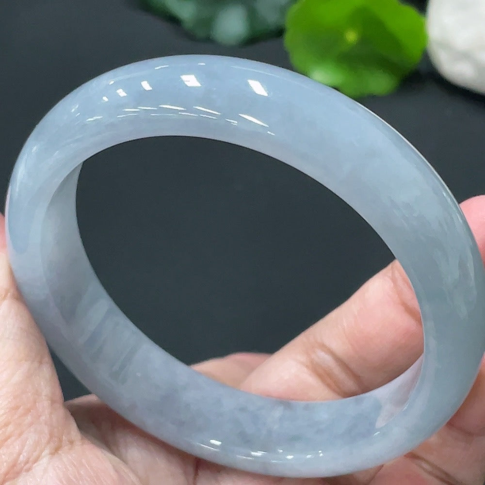 Huiliu Certified HKHQ jadeite round bangle showcasing smooth, polished green jade with a glossy finish.