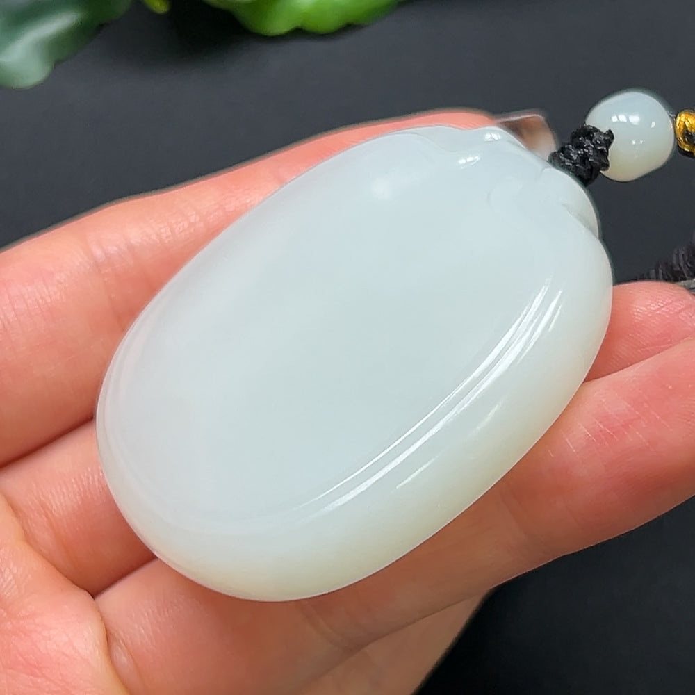 HKHQ Hetian Jade plain pendant with rope, approximately 64.08g, showcasing smooth, polished jade in a simple, elegant design.