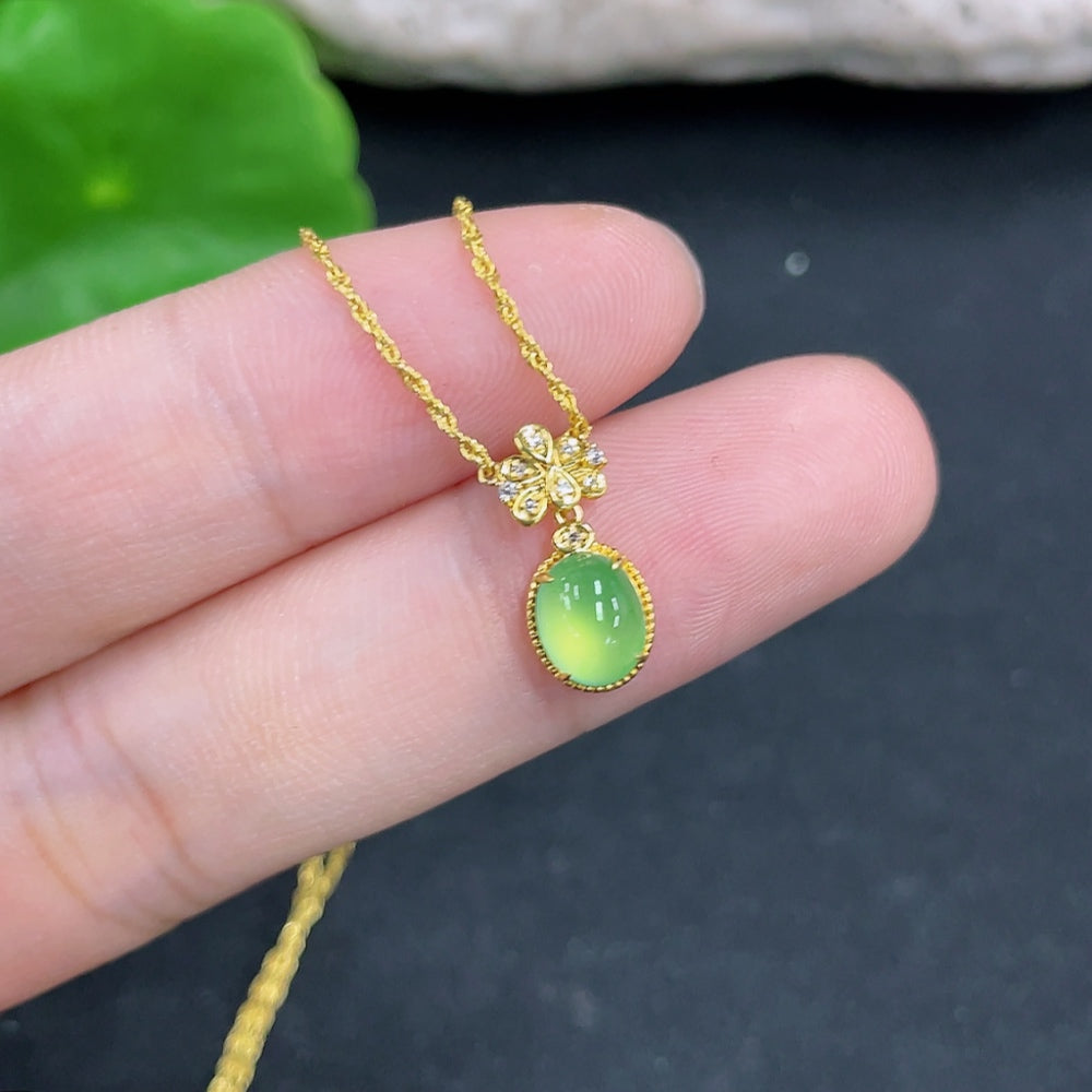 HKHQ jadeite pendant with 18k gold and diamond accents, including chain, showcasing a polished green jade gemstone.