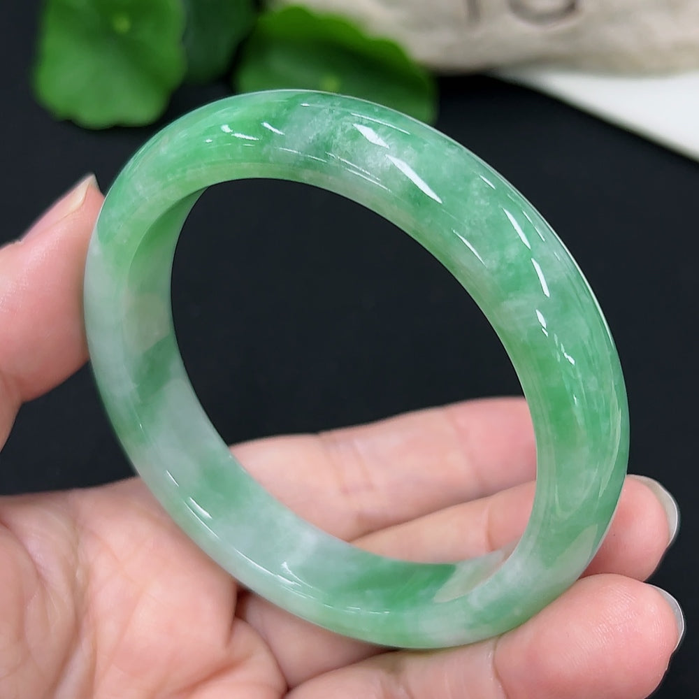 Jadeite round bangle with size 55.1 and weight 50.4g, crafted from green jade, displayed on a neutral background.