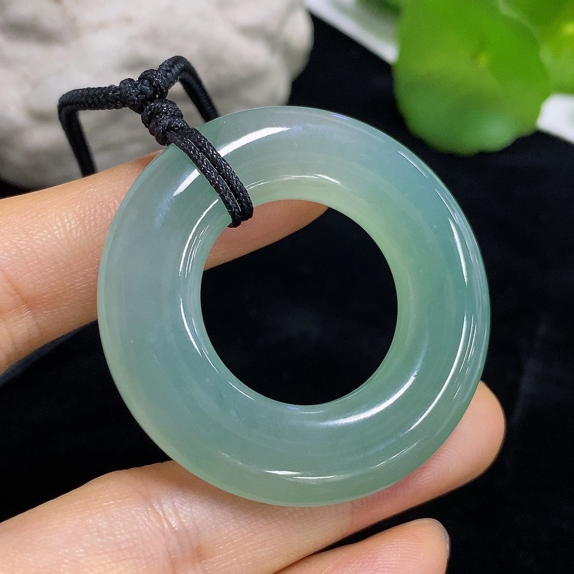 Jadeite peace ring pendant with carved jade design, silver bail, and smooth polished surface, displayed against a plain background.