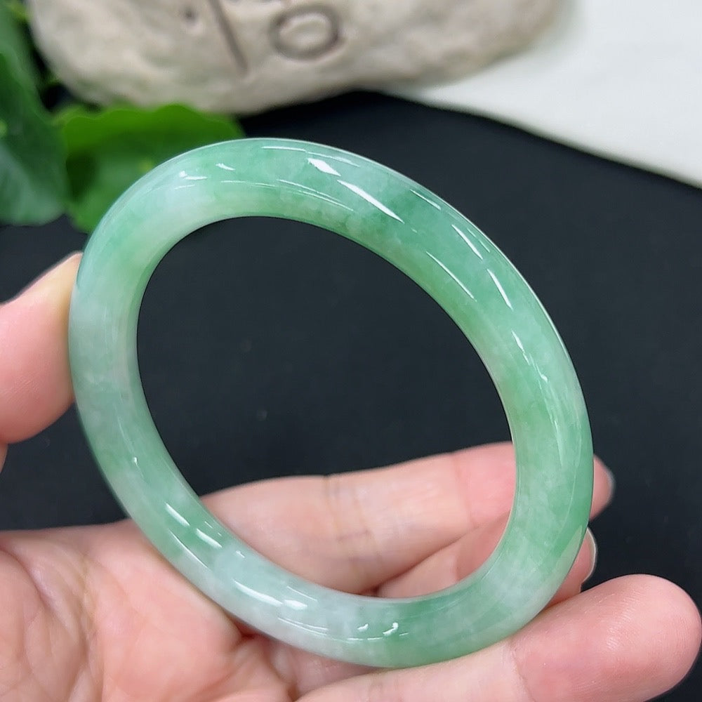 HKHQ jadeite round bangle in size 56, weighing approximately 43 grams, showcasing smooth, polished green jadeite bracelet.