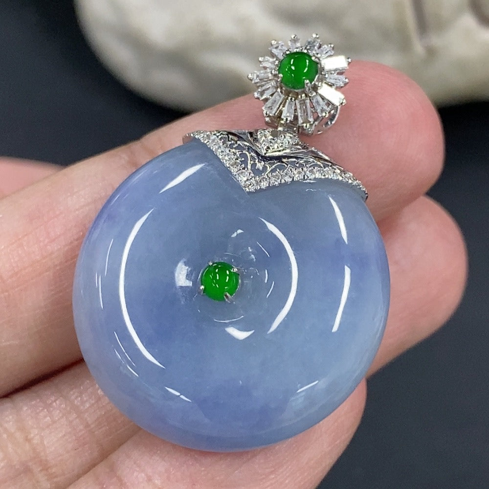 Jadeite Peace Knot pendant with 18K gold clasp and diamond accents, shown on a neutral background.