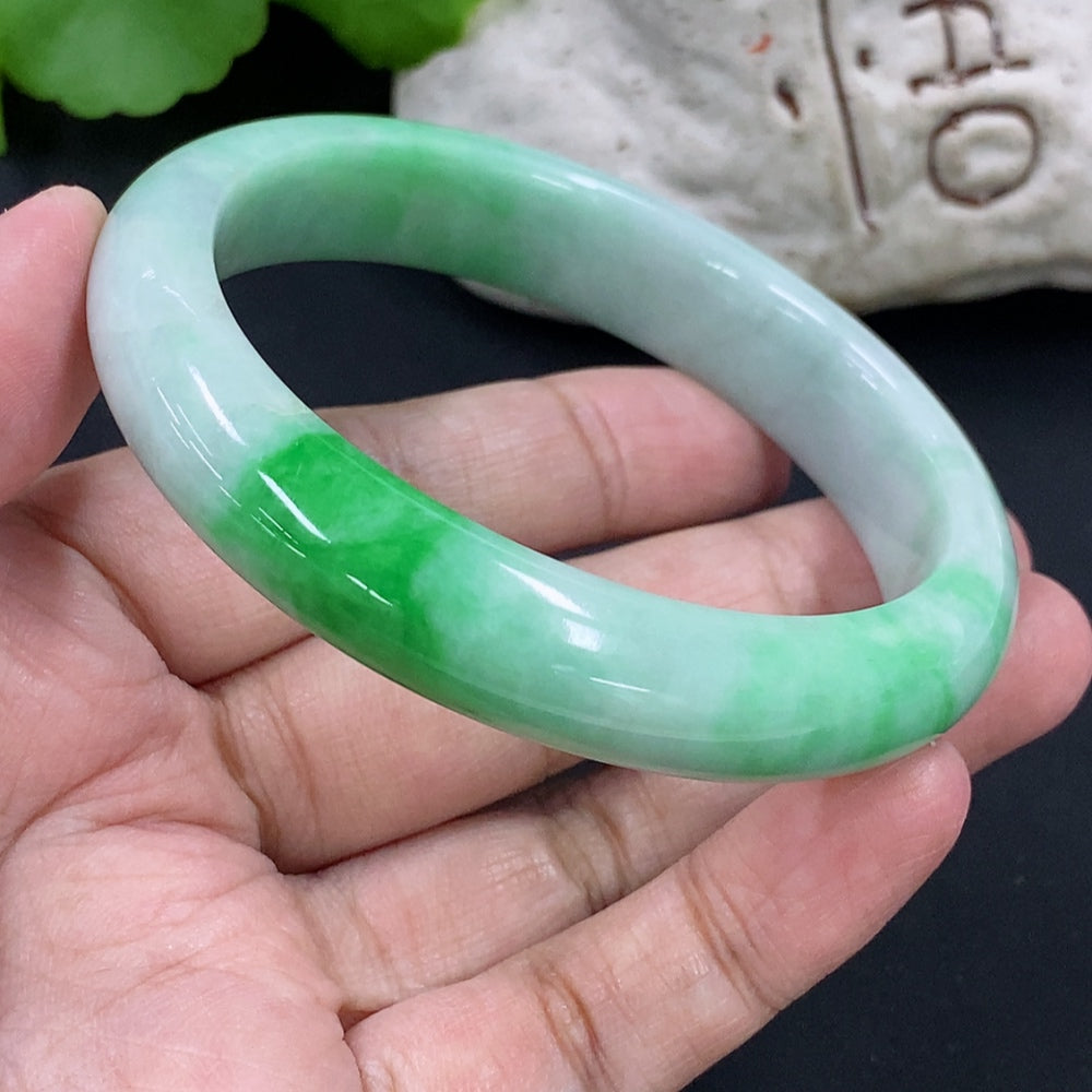 Jadeite round bracelet with HKHQ branding, weighing 54.97g, featuring smooth green jade beads, size 56.9 mm, on a plain background.