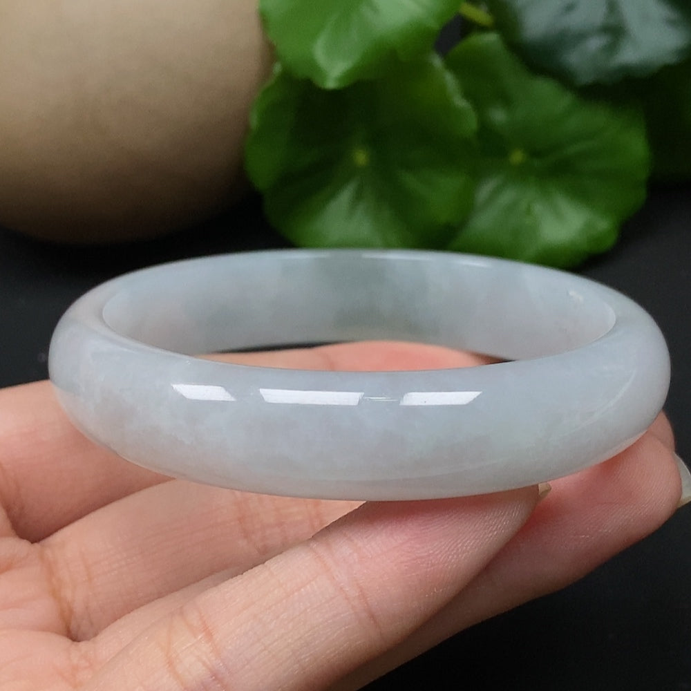 HKHQ jadeite round bangle, size 56.5, weighs approx. 43.17g, showcasing smooth, polished green jadeite in a close-up view.