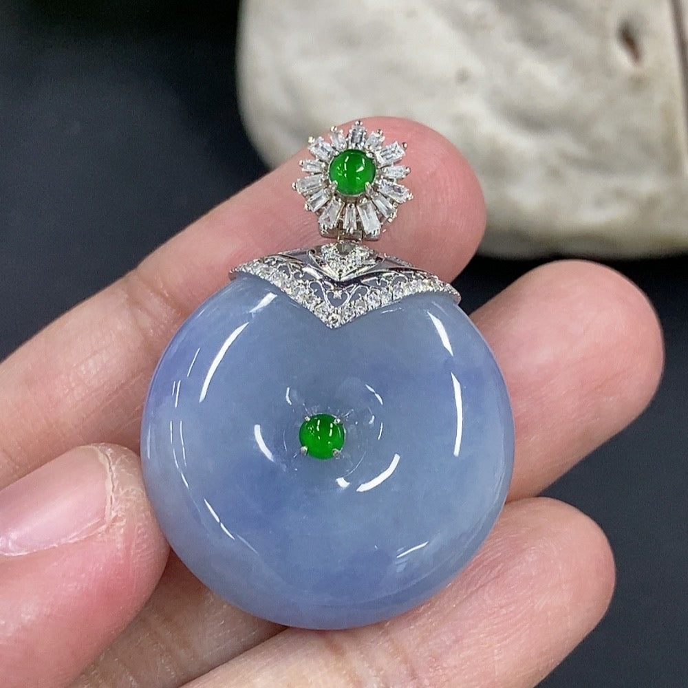 Jadeite Peace Knot pendant by HKHQ with 18K gold clasp and diamond accents, showcasing intricate design and polished surface.