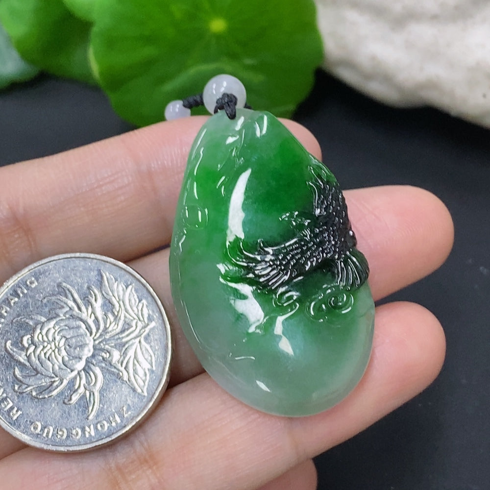 Jadeite pendant with mineral components, weighing approx. 19.9g including chain, displayed against a neutral background.