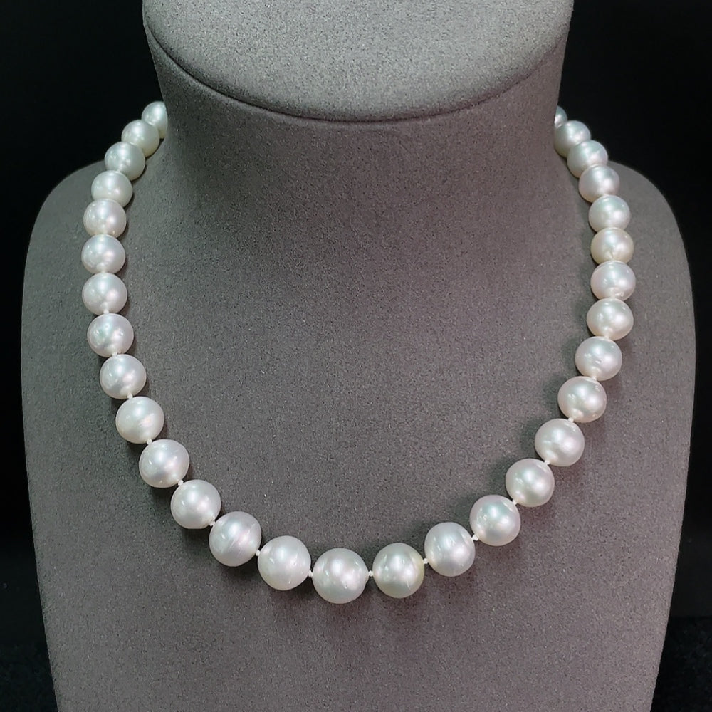 Seawater pearl strand by HKHQ with 8.9-11.6mm pearls, total weight approx. 63.95g, showcasing lustrous round pearls on a display.